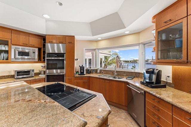 kitchen featuring a sink, a toaster, brown cabinets, and stainless steel appliances