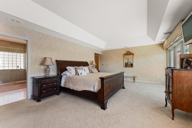 bedroom featuring wallpapered walls, a raised ceiling, baseboards, and light carpet