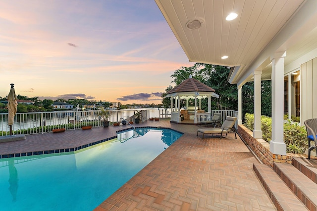 view of swimming pool featuring a gazebo, a fenced in pool, fence, and a patio area