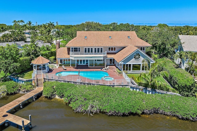 back of house featuring a gazebo, a fenced backyard, a balcony, and a water view