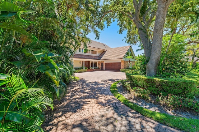 view of front of house with brick siding and decorative driveway