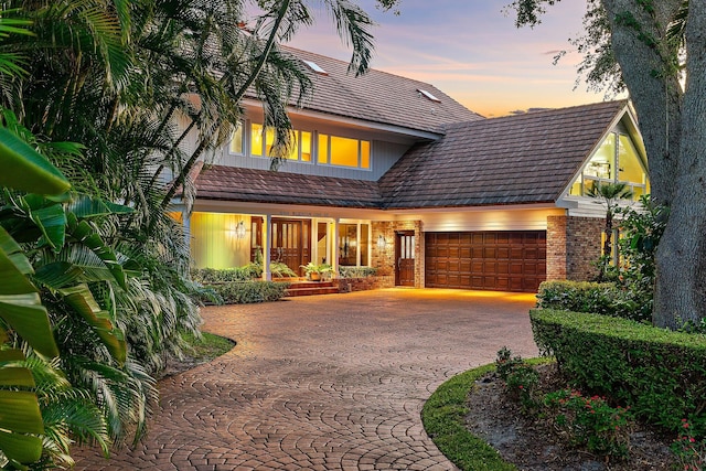 view of front of house featuring a garage and brick siding