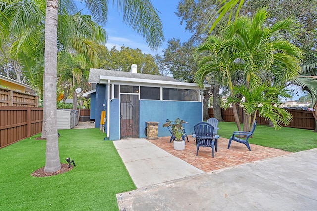 exterior space with a yard and a sunroom