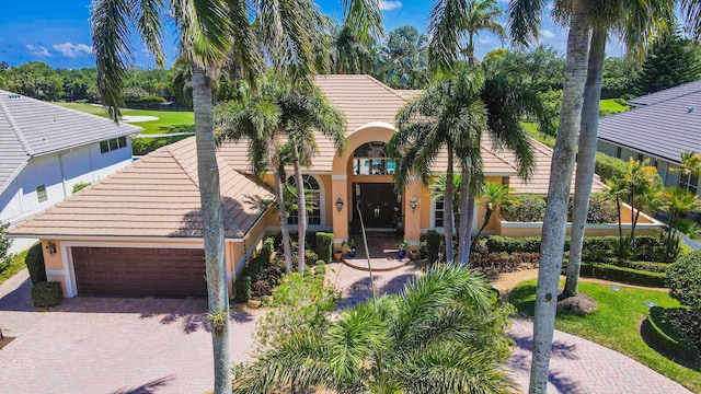 mediterranean / spanish-style home featuring a garage