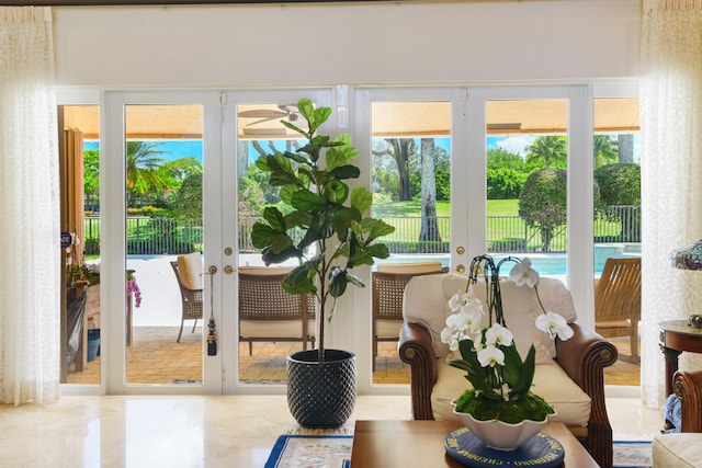 sunroom / solarium featuring french doors and a healthy amount of sunlight