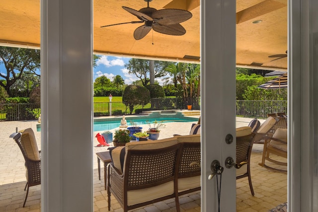 view of patio / terrace with ceiling fan and a fenced in pool