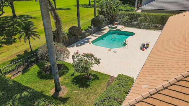 view of swimming pool featuring a yard and a patio