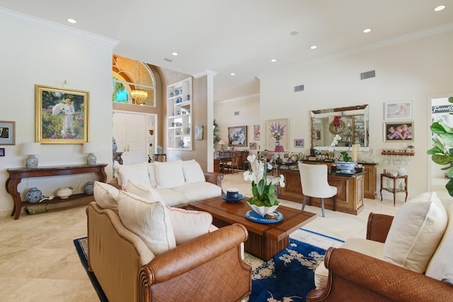 living room with crown molding and a high ceiling