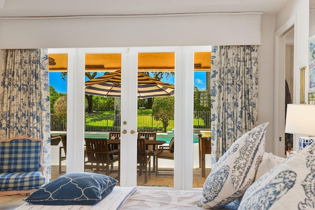 bedroom featuring multiple windows, access to outside, and french doors