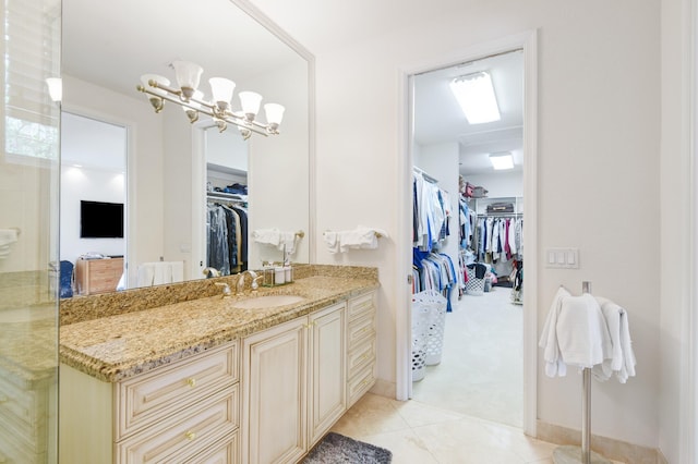 bathroom featuring vanity, tile patterned flooring, and a notable chandelier