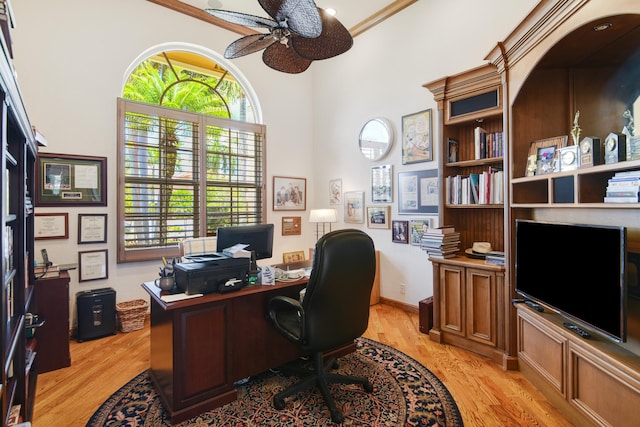 office with light wood-type flooring, ceiling fan, and ornamental molding