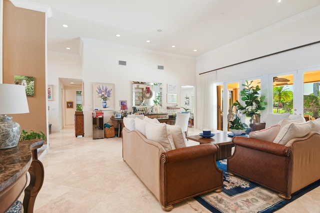 living room featuring french doors, a towering ceiling, and crown molding