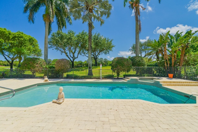 view of pool with a patio area and an in ground hot tub