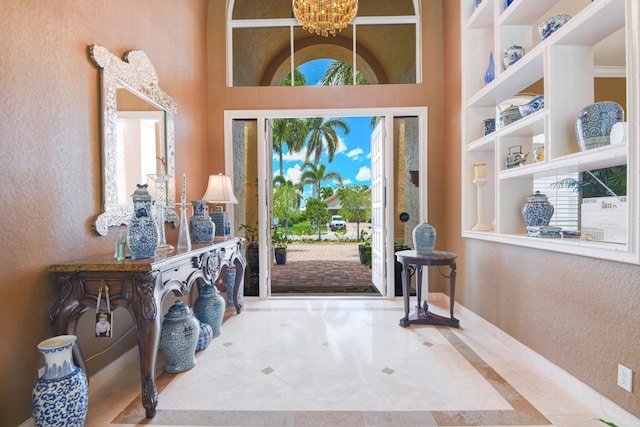 entrance foyer featuring an inviting chandelier