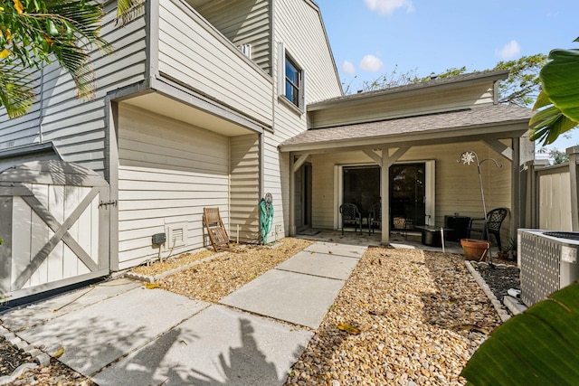 view of exterior entry with a patio, an outdoor hangout area, and cooling unit