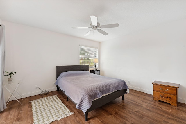 bedroom with ceiling fan and dark hardwood / wood-style flooring