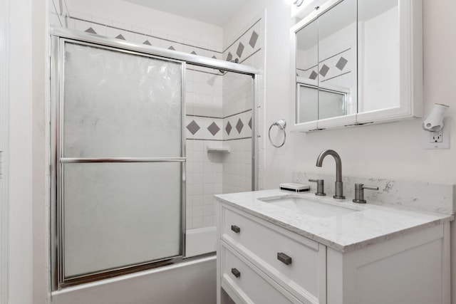 bathroom featuring vanity and combined bath / shower with glass door