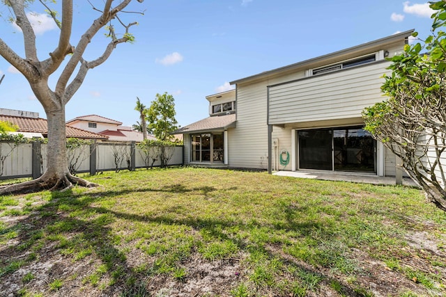 back of property featuring a yard