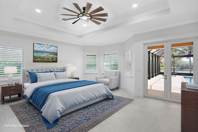 bedroom featuring a raised ceiling, access to exterior, and french doors