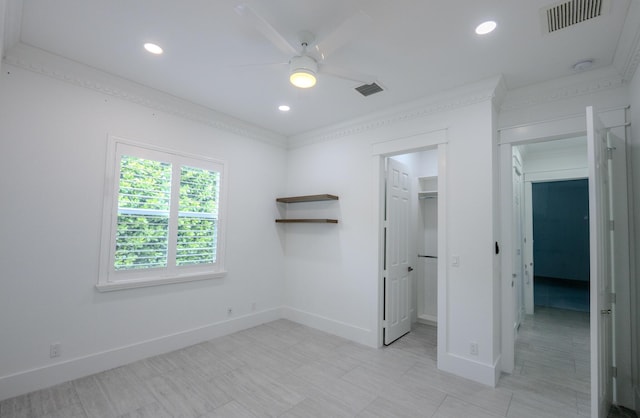 unfurnished bedroom featuring a walk in closet, ceiling fan, and a closet