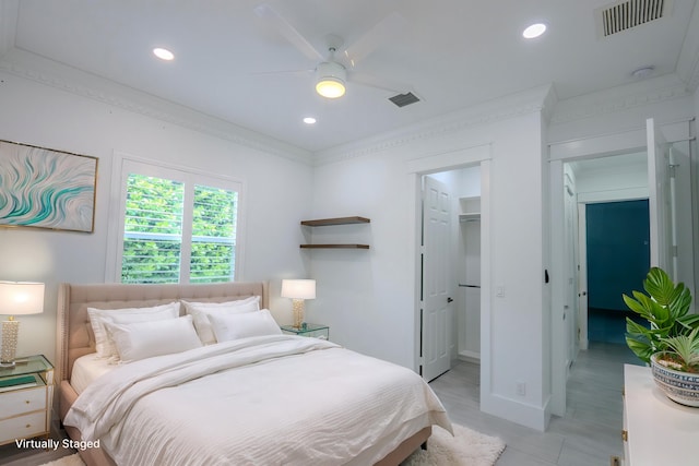 bedroom featuring ceiling fan, a walk in closet, and a closet