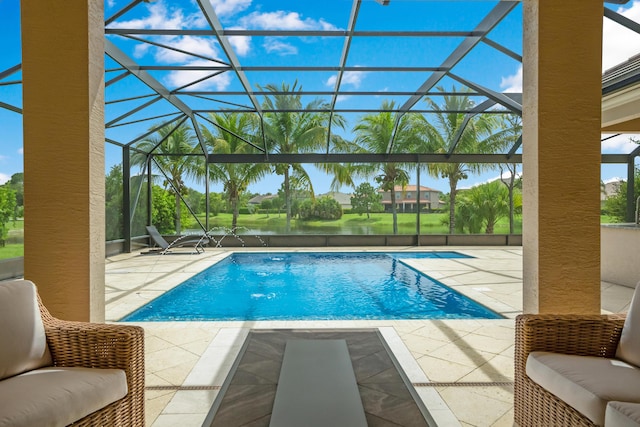 view of pool featuring pool water feature, glass enclosure, and a patio area