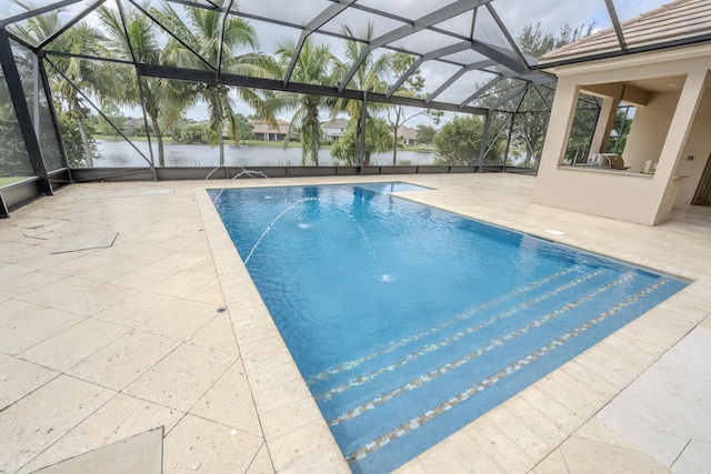 view of swimming pool with a lanai, pool water feature, a water view, and a patio