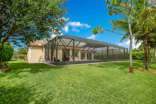 rear view of property with a yard and glass enclosure