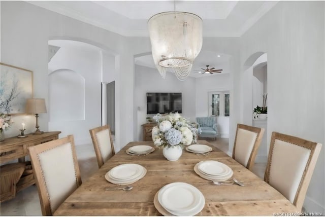 dining room featuring ceiling fan with notable chandelier and ornamental molding