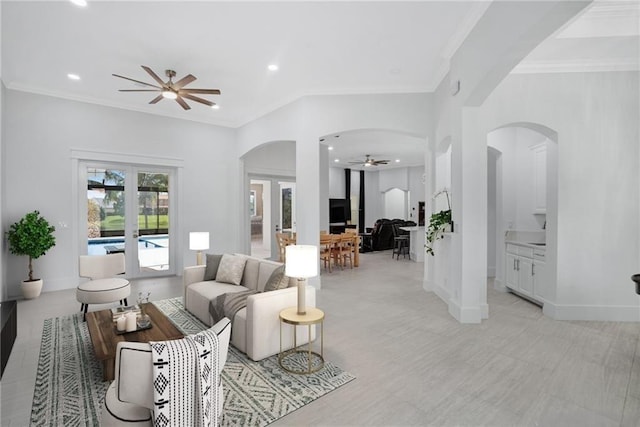 living room with crown molding and ceiling fan