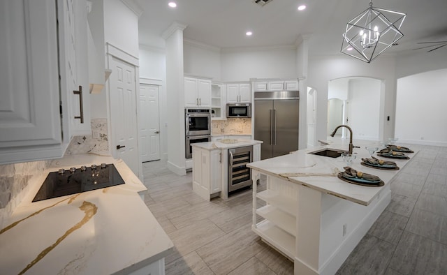 kitchen featuring pendant lighting, a center island, sink, wine cooler, and stainless steel appliances