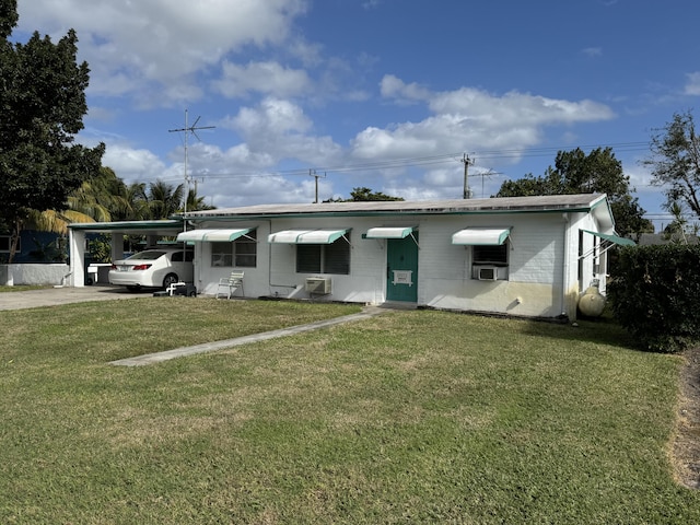 ranch-style house with cooling unit, a front yard, and a carport