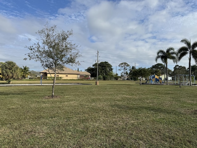 view of community featuring a playground and a yard