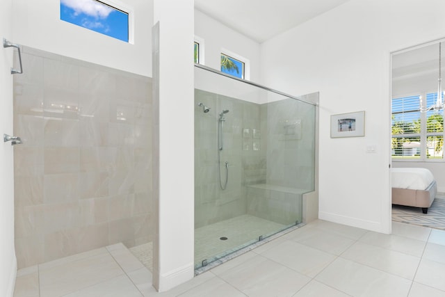 bathroom featuring tile patterned flooring and tiled shower