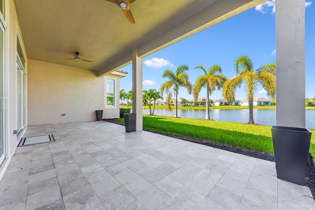 view of patio / terrace featuring ceiling fan and a water view