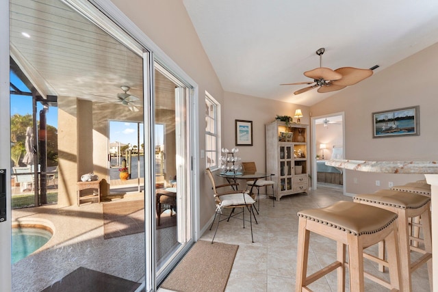 interior space featuring vaulted ceiling and light tile patterned flooring