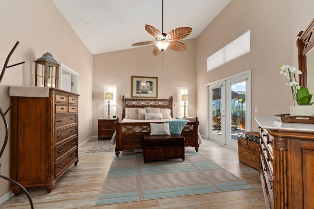 bedroom featuring access to exterior, french doors, light wood-type flooring, ceiling fan, and high vaulted ceiling