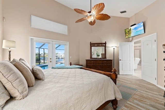 bedroom featuring ceiling fan, light wood-type flooring, access to outside, and french doors