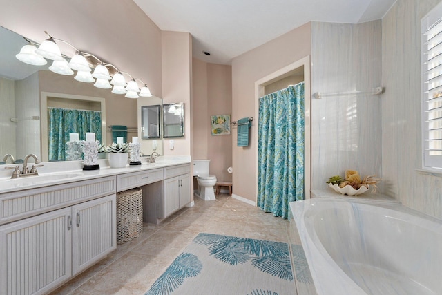 bathroom featuring tiled tub, vanity, and toilet