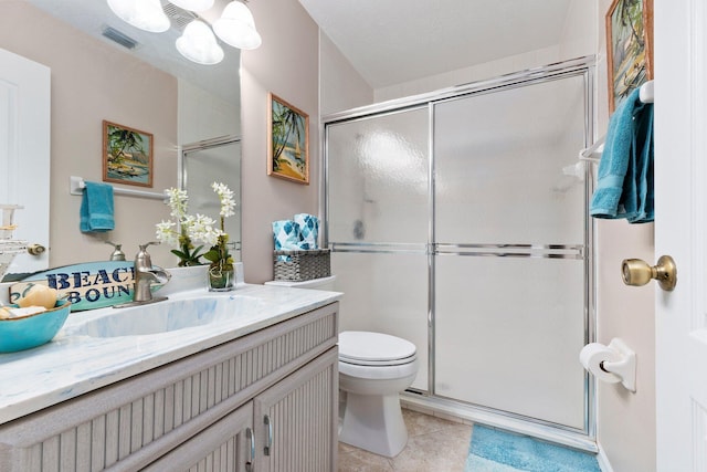 bathroom with vanity, toilet, and a shower with shower door