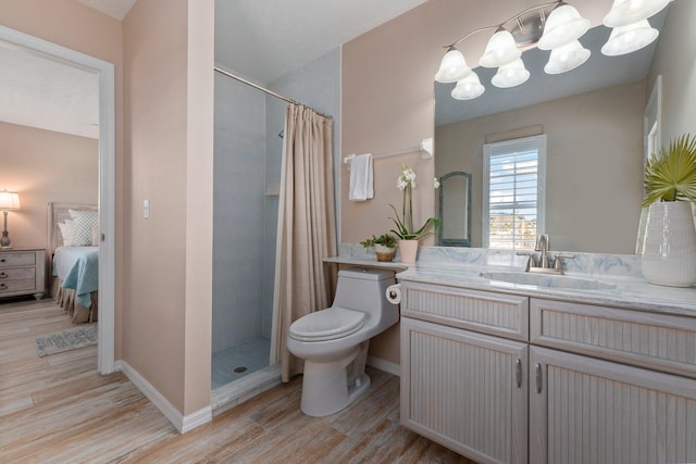 bathroom with vanity, wood-type flooring, a notable chandelier, toilet, and curtained shower