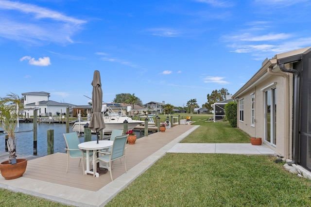 dock area featuring a yard and a water view