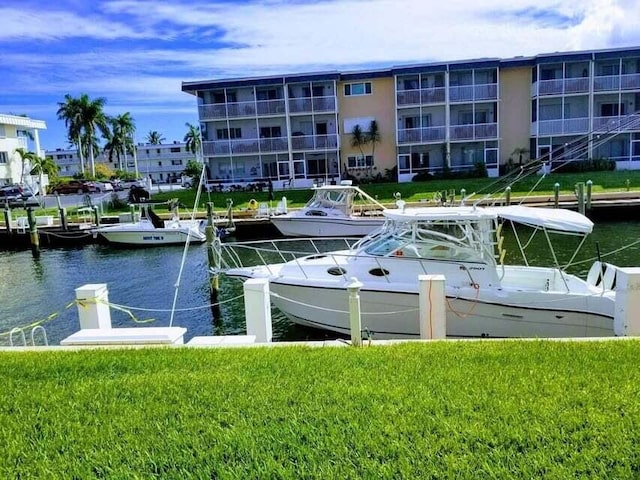 dock area with a yard and a water view