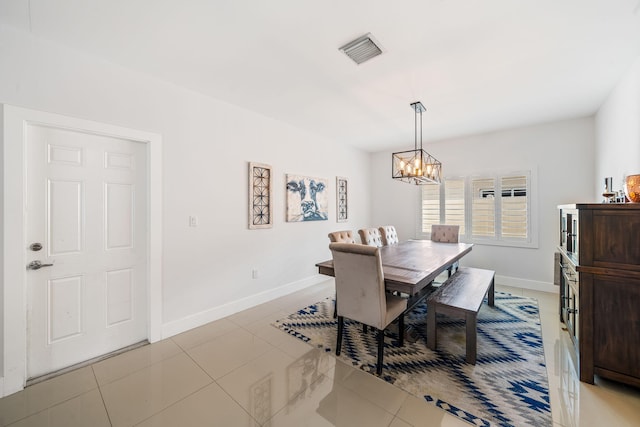 tiled dining space featuring a chandelier