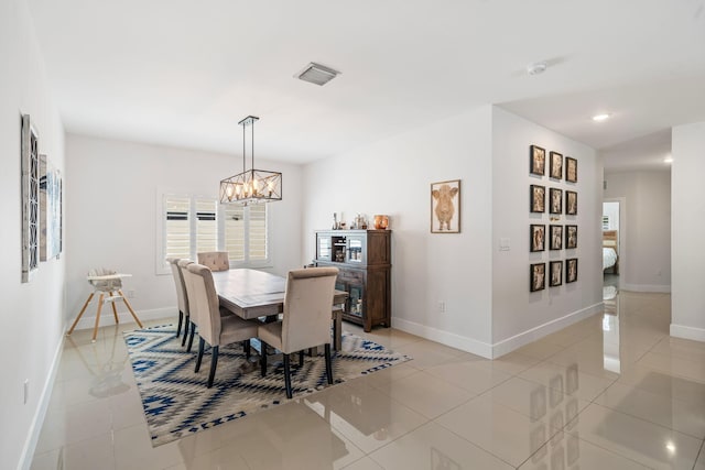 tiled dining area with an inviting chandelier