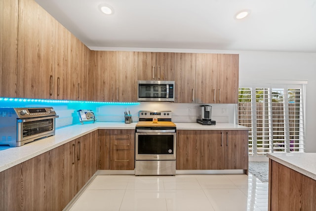 kitchen featuring light tile patterned floors and appliances with stainless steel finishes