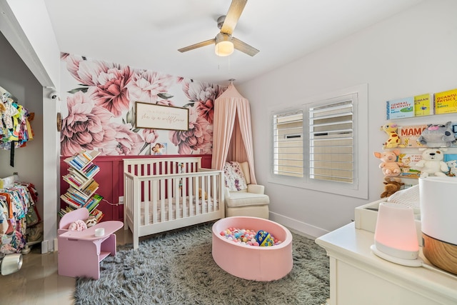 bedroom featuring a crib and ceiling fan