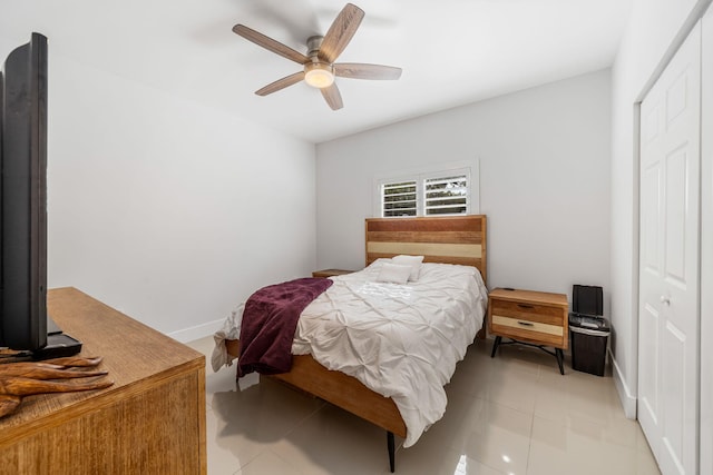 tiled bedroom featuring a closet and ceiling fan