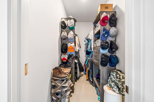 spacious closet with light tile patterned floors