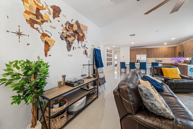 living room featuring ceiling fan and light tile patterned floors